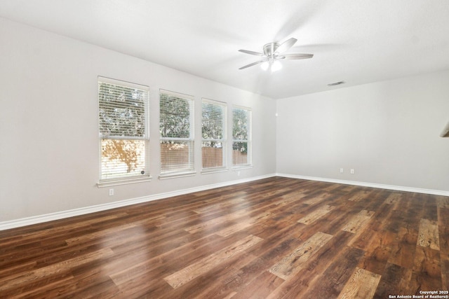 empty room with ceiling fan and dark wood-type flooring