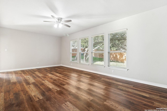 unfurnished room featuring dark hardwood / wood-style flooring, plenty of natural light, and ceiling fan