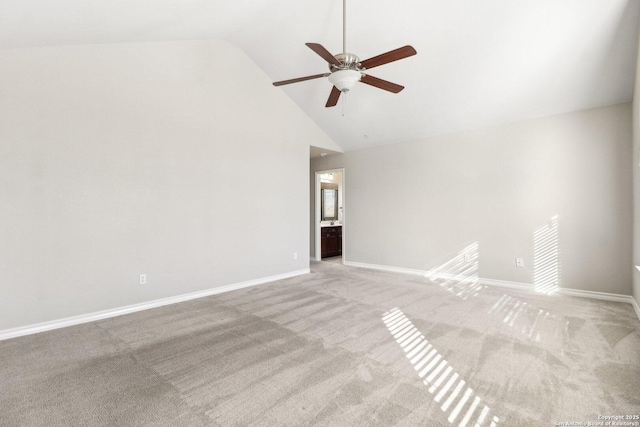 carpeted spare room with ceiling fan and high vaulted ceiling