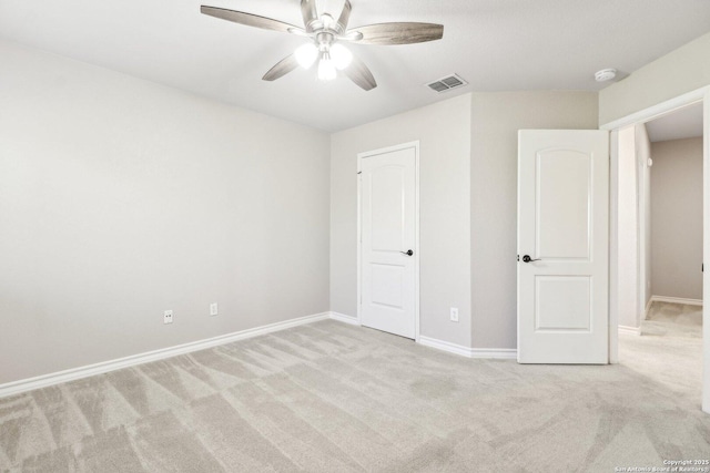 unfurnished bedroom with light colored carpet and ceiling fan