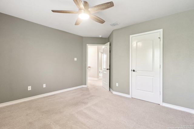 unfurnished bedroom featuring light colored carpet and ceiling fan