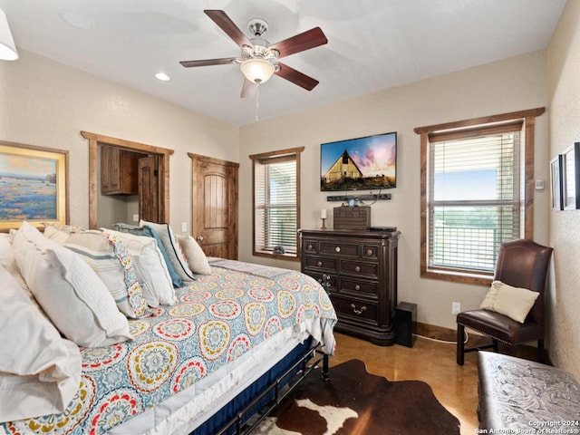 bedroom with multiple windows and ceiling fan