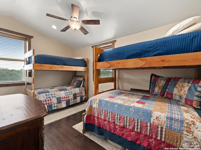 bedroom with dark hardwood / wood-style flooring, ceiling fan, and lofted ceiling