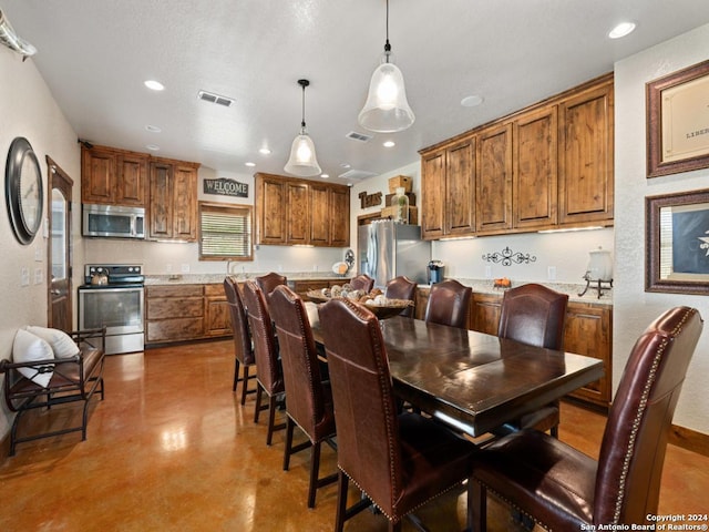 dining room featuring concrete flooring