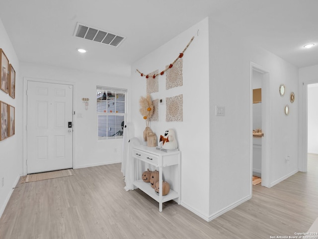 hallway with light hardwood / wood-style flooring