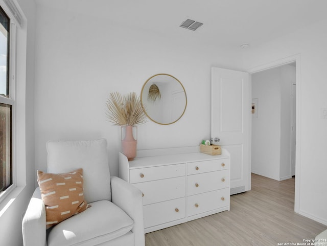 living area with light hardwood / wood-style floors and a wealth of natural light