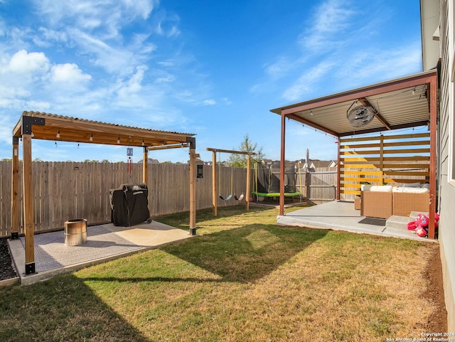 view of yard with outdoor lounge area, a patio, and a trampoline