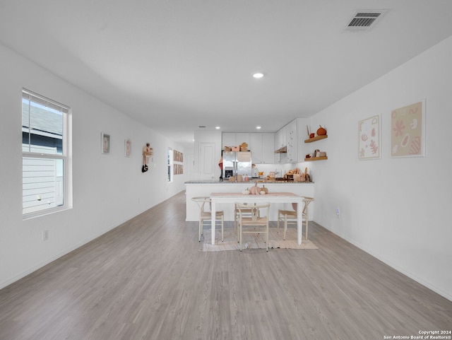 unfurnished dining area with light hardwood / wood-style flooring