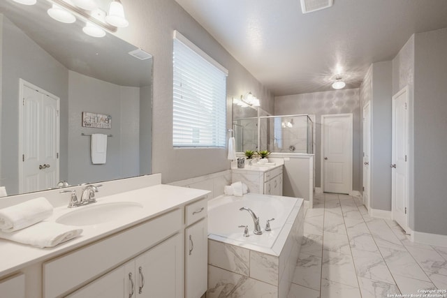 bathroom featuring vanity and shower with separate bathtub