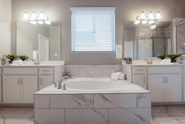 bathroom with vanity and independent shower and bath