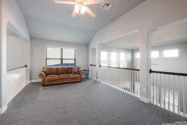 sitting room featuring ceiling fan, carpet floors, and vaulted ceiling