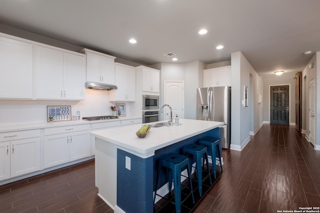 kitchen with white cabinets, sink, an island with sink, and stainless steel appliances