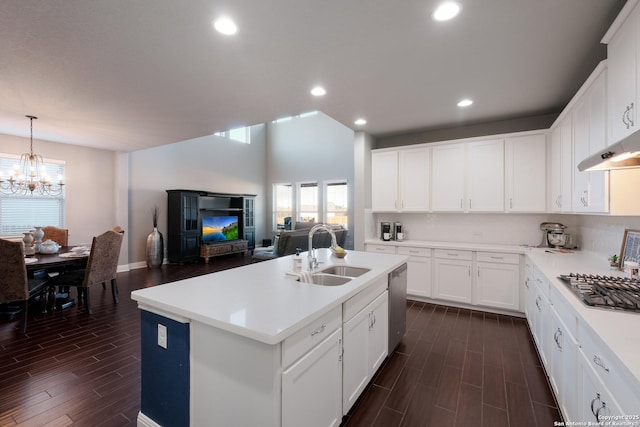 kitchen featuring stainless steel appliances, sink, decorative light fixtures, a center island with sink, and white cabinetry