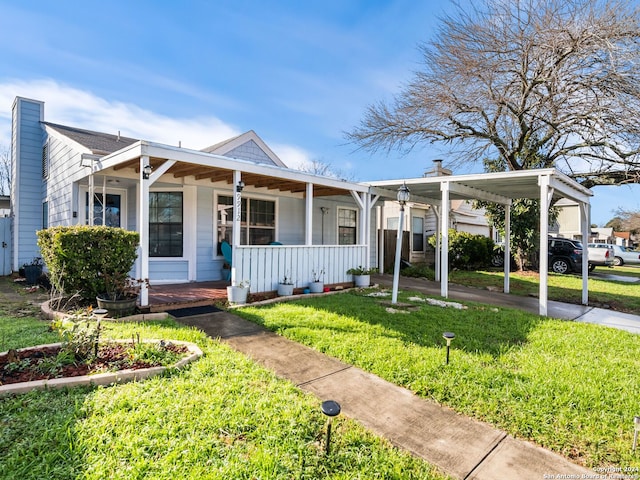 view of front of house with a porch, a carport, and a front lawn