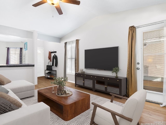 living room featuring ceiling fan, vaulted ceiling, and hardwood / wood-style flooring