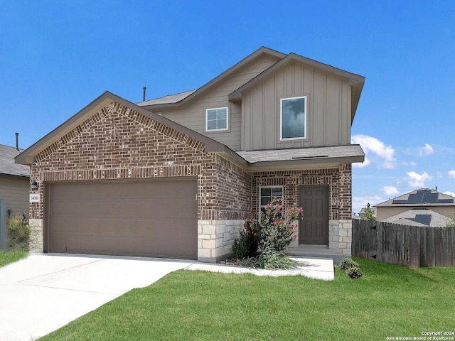 front of property with a garage and a front lawn