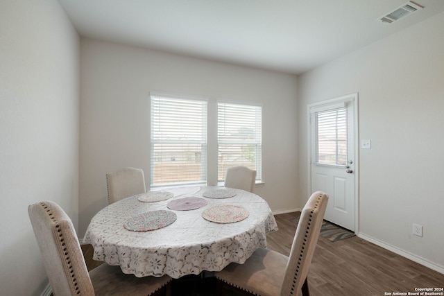 dining room with dark hardwood / wood-style flooring