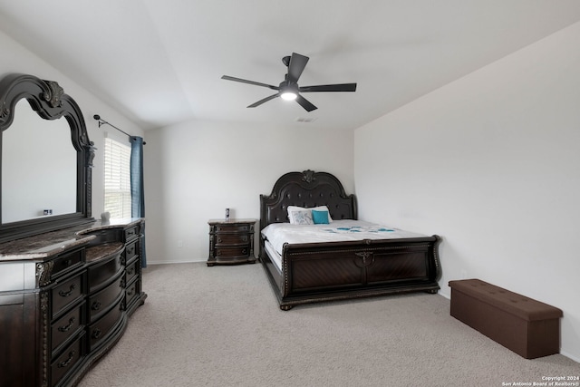 bedroom with ceiling fan, light carpet, and lofted ceiling