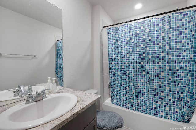 full bathroom with shower / bathtub combination with curtain, vanity, and toilet