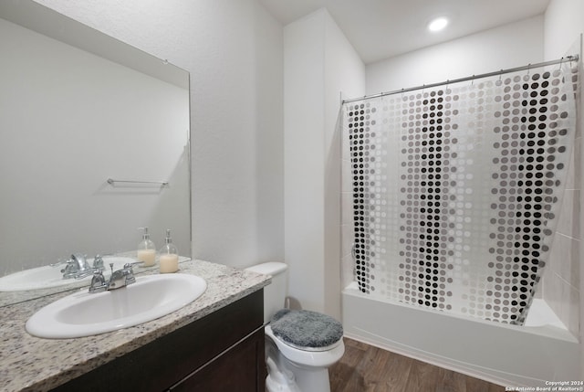 full bathroom featuring shower / tub combo with curtain, vanity, wood-type flooring, and toilet