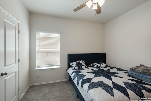 bedroom featuring light colored carpet and ceiling fan