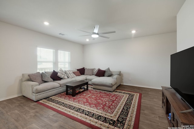 living room featuring hardwood / wood-style flooring and ceiling fan