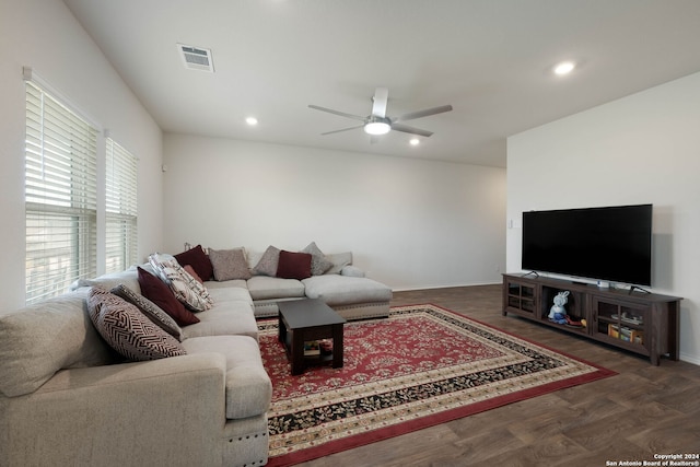 living room featuring dark hardwood / wood-style flooring and ceiling fan