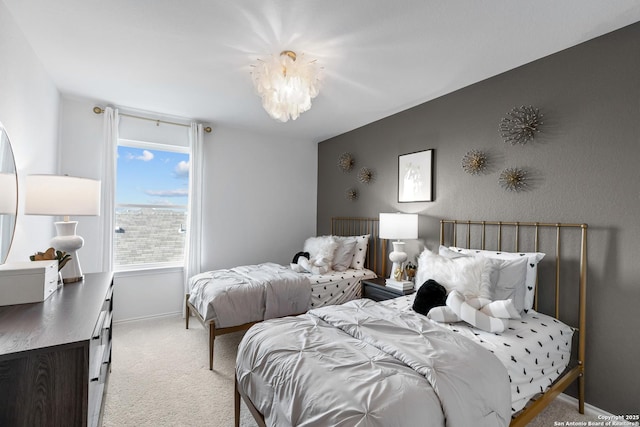 bedroom with light carpet and a chandelier