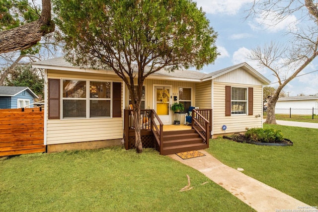 bungalow-style house with a front lawn and covered porch