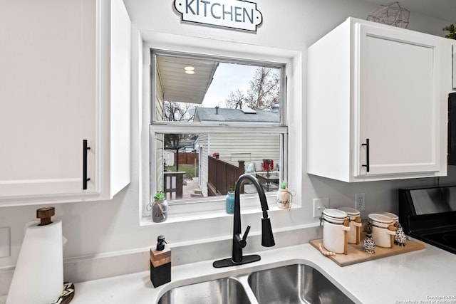 kitchen featuring white cabinets and sink