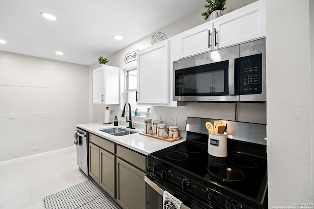 kitchen with white cabinets, sink, light tile patterned floors, and stainless steel appliances