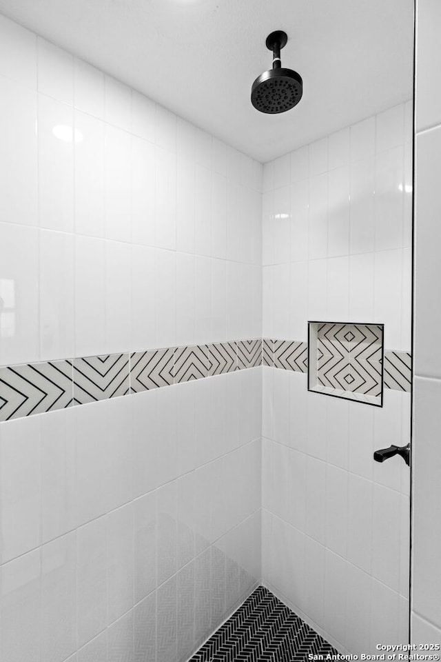 bathroom with a tile shower