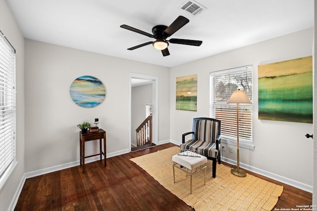 sitting room featuring plenty of natural light, ceiling fan, and dark hardwood / wood-style flooring