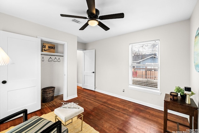 sitting room with dark hardwood / wood-style floors and ceiling fan