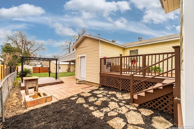 rear view of house with a deck, a pergola, and a patio