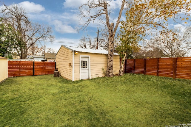 view of outbuilding with a yard