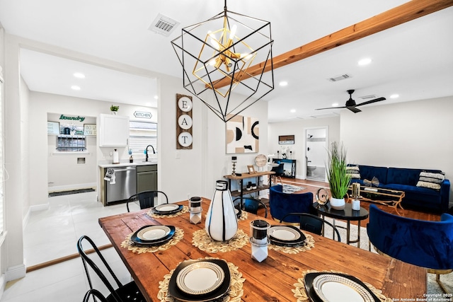 dining area featuring beamed ceiling, ceiling fan with notable chandelier, and sink