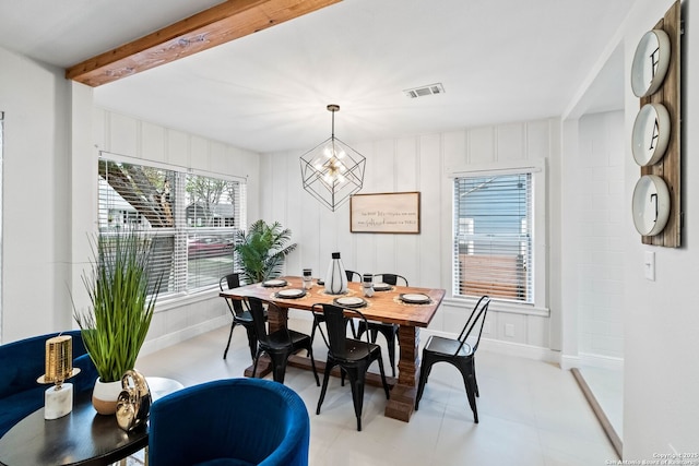 dining room with a notable chandelier and beam ceiling