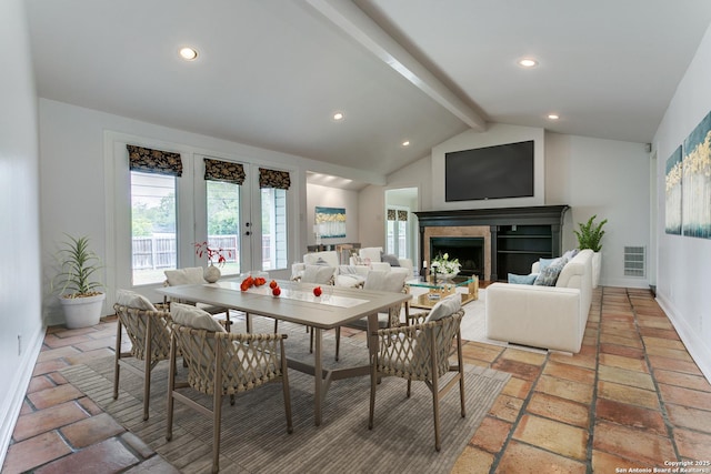 dining room with french doors and lofted ceiling with beams