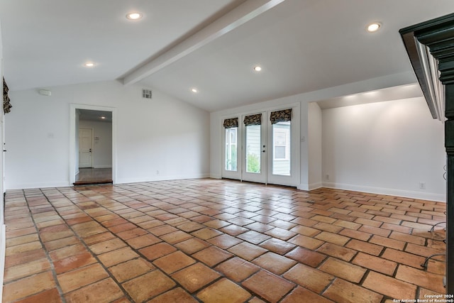 empty room with french doors and vaulted ceiling with beams