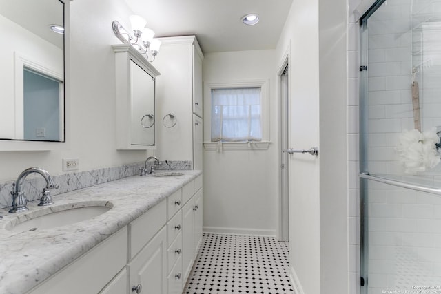 bathroom with vanity and a shower with door