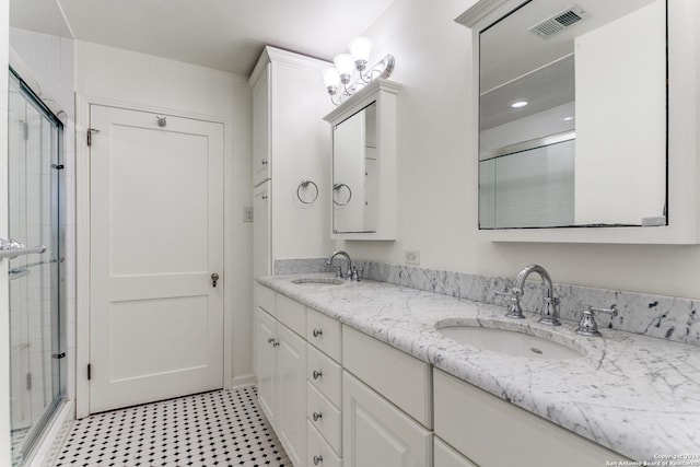 bathroom featuring vanity and a shower with door