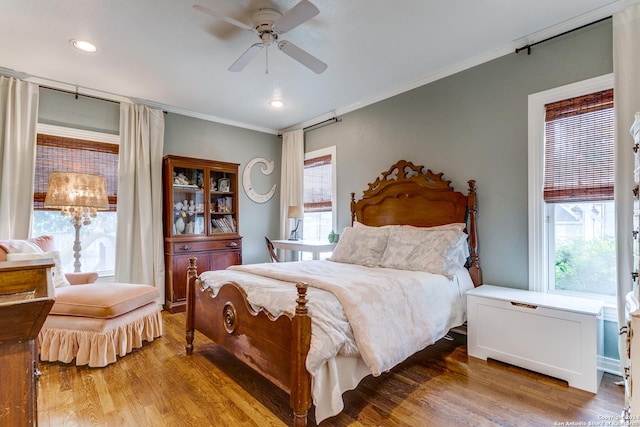 bedroom with wood-type flooring, ceiling fan, and ornamental molding