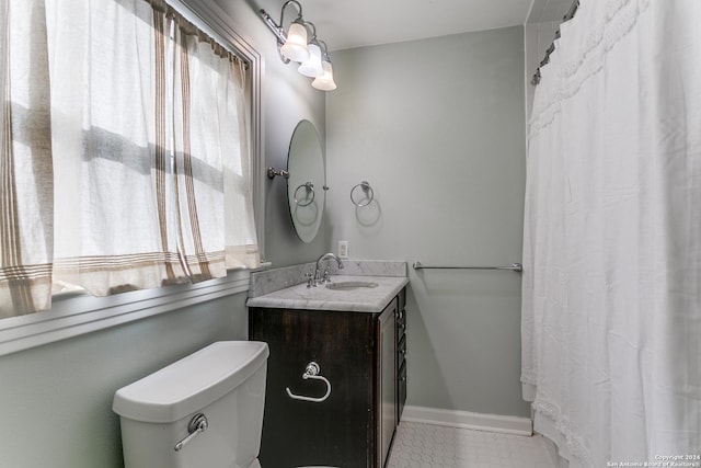 bathroom with tile patterned floors, vanity, and toilet