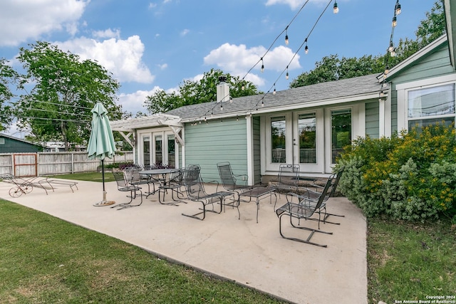 rear view of house with a patio area and french doors