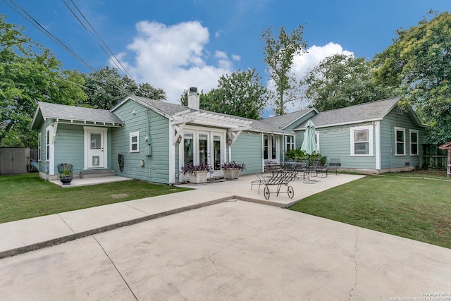 rear view of house with a yard and a patio