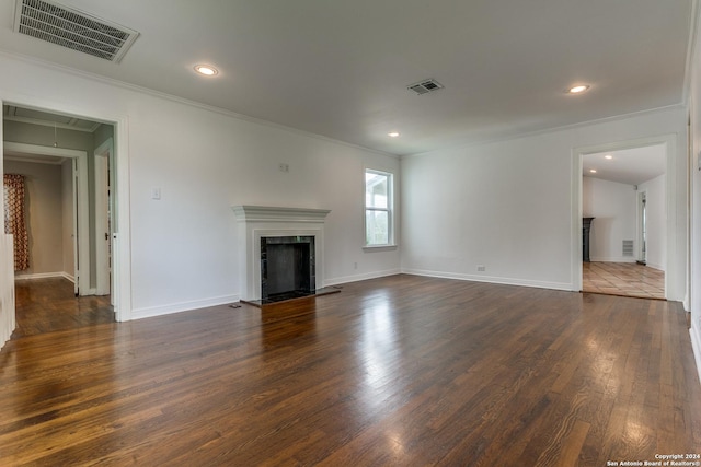 unfurnished living room with dark hardwood / wood-style floors and crown molding