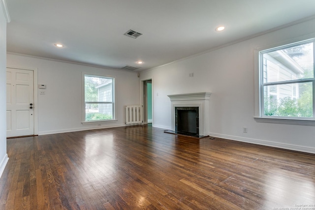 unfurnished living room featuring dark hardwood / wood-style flooring, ornamental molding, and radiator