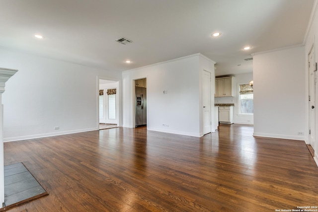 unfurnished living room with dark hardwood / wood-style floors and crown molding