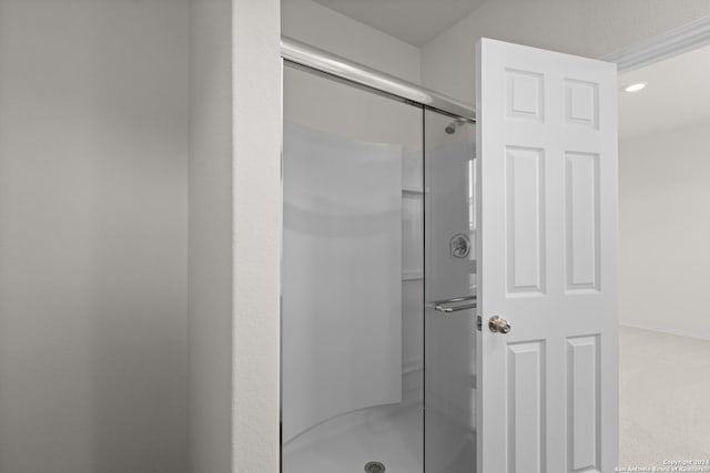 bathroom with a shower with door